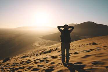 Namibia, Namib Desert, Sossusvlei, Woman enjoying sunrise on the Dune 45 - GEMF000560