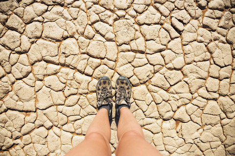 Namibia, Namib Desert, Sossusvlei, Trekking shoes on dry cracked earth stock photo