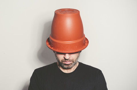 Man with flowerpot on his head stock photo