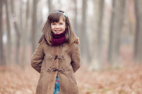 Young girl, brown coat in park, autum, smiling stock photo