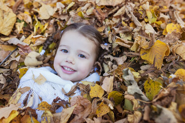 Happy girl lying in autumn leaves - HAPF000065