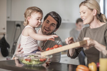 Family in kitchen preparing food together - ZEF007692