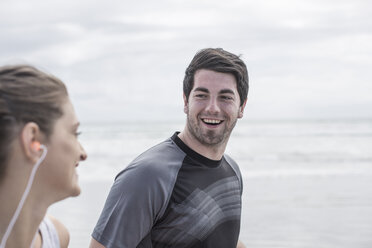 Young man and woman running on beach - ZEF007727