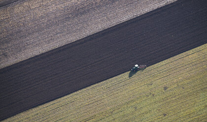 Austria, tractor on field, aerial view - STCF000103