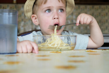 Porträt eines kleinen Jungen, der Spaghetti isst - ABAF001966