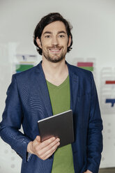 Man with tablet PC standing in office - MFF002545
