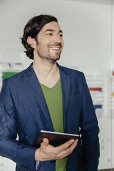 Man with tablet PC standing in office - MFF002546