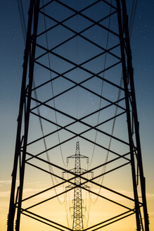 Austria, Braunau am Inn District, power pylons in the evening - OPF000097