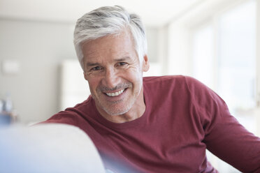 Portrait of smiling mature man with grey hair and stubble - RBF003804