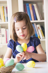 Portrait of little girl playing with Easter eggs - LVF004338