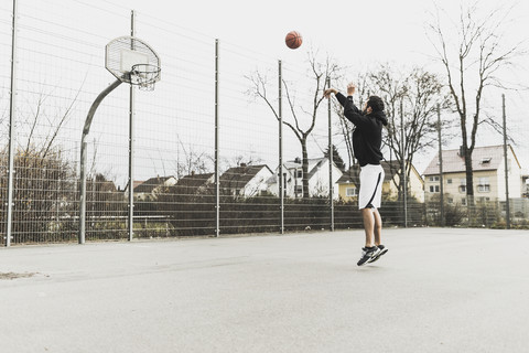 Young man playing basketball stock photo