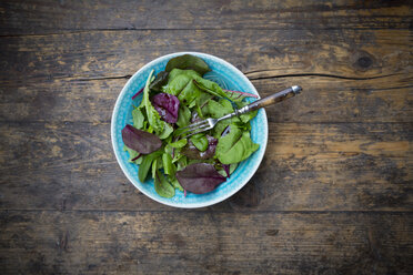 Bowl of organic mixed salad on dark wood - LVF004360