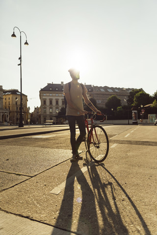 Young man with racing cycle in Vienna, bicycle lane, Dr.-Karl-Renner-Ring stock photo