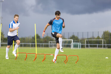 Two soccer players exercising on sports field - SHKF000391