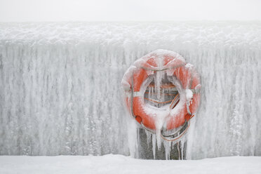 Germany, Sassnitz, life belt on icy wall in winter - ASCF000433