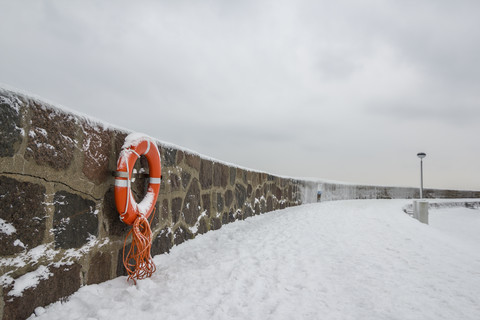 Germany, Sassnitz, life belt on wall in winter stock photo