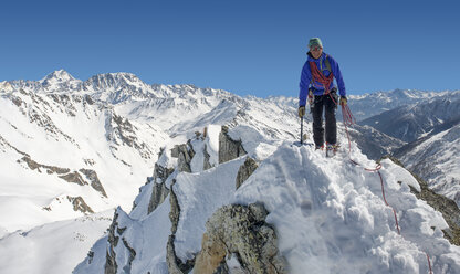 Italy, Grand St Bernard Pass, Mont Fourchon, smiling man on summit - ALRF000292