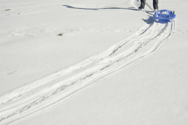 Spain, La Molina, man with plastic sledge - SKCF000039