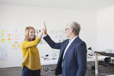 Businessman and coworker giving high five - RBF003958