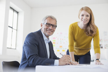 Businessman and coworker working in office - RBF003969