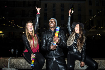 Enthusiastic friends having a party outdoors at night - OIPF000055