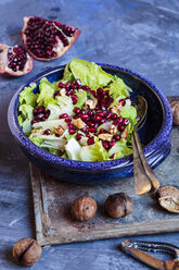 Bowl of Romaine lettuce with walnuts, pomegranate dressing and seed - SBDF002618