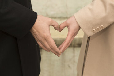 Man and woman shaping hands to a heart - FCF000820