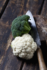 Broccoli, cauliflower and knife on dark wood - CSF026980