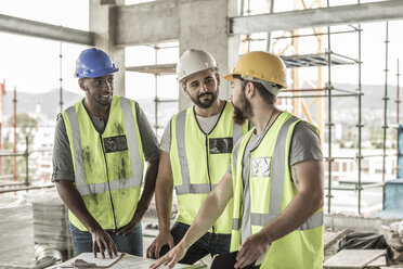 Bauarbeiter, die auf einer Baustelle diskutieren - ZEF007831