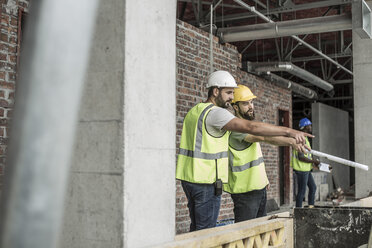 Bauarbeiter, die auf einer Baustelle diskutieren - ZEF007841