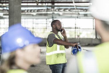 Construction worker on cell phone in construction site - ZEF007874