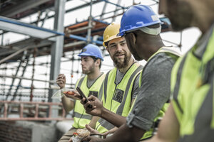 Construction workers having a break on construction site - ZEF007879