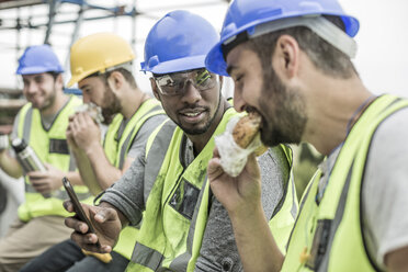 Construction workers having lunch break on construction site - ZEF007881
