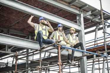 Construction workers having a break on scaffolding - ZEF007882