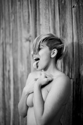 Portrait of nude woman with closed eyes sticking out tongue - JPF000090