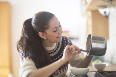 Smiling woman preparing dessert - SGF001995