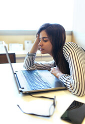 Businesswoman at her desk looking at laptop - MGOF001225