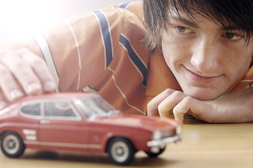 Portrait of smiling teenage boy with Ford Capri model car - GUFF000185
