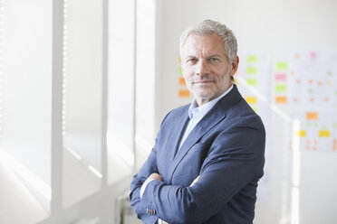 Portrait of confident businessman in office - RBF003993