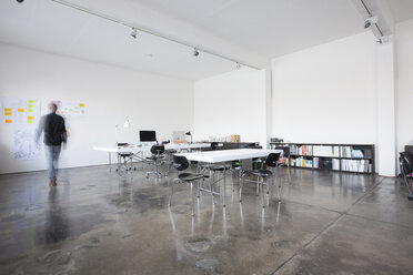 Businessman walking in conference room - RBF004015