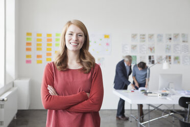 Portrait of smiling young woman in office - RBF004020