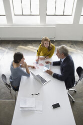 Businessman and two women in conference room having a meeting - RBF004040