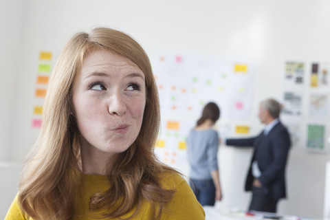 Young woman in office thinking stock photo