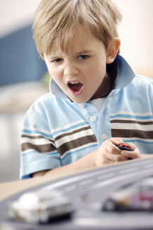 Portrait of blond little boy playing with Carrera - GUFF000218