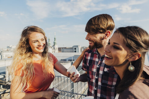 Austria, Vienna, Young people having a party on rooftop terrace - AIF000235