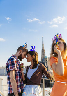 Austria, Vienna, Young people having a party on rooftop terrace - AIF000248