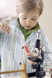 Portrait of little boy with test tubes and microscope - GUFF000244