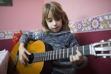 Boy playing Spanish guitar - RAEF000777