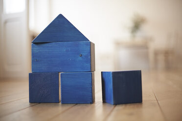Blue wooden building bricks shaping a house - FMKF002271