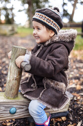 Happy little girl on a playground in autumn - MGOF001238